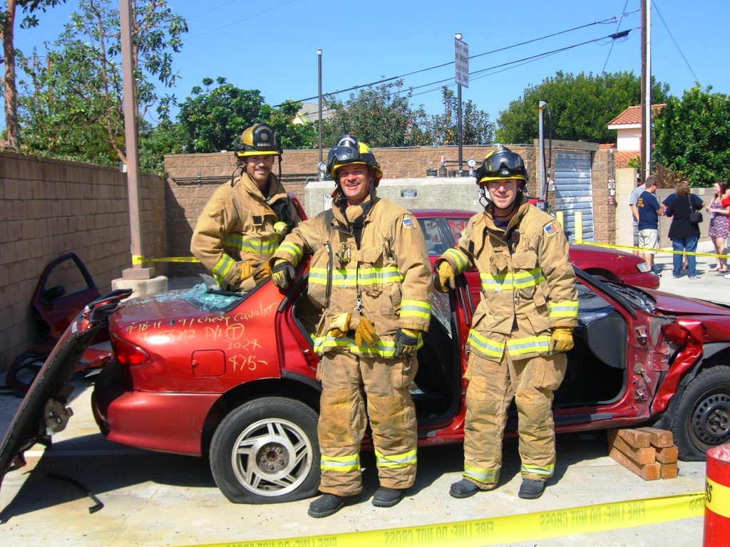 Firefighters in front of a demolished vehicle